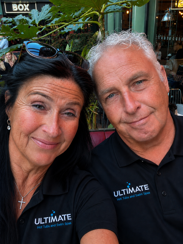 Two members of the Ultimate Hot Tubs team wearing branded polo shirts
